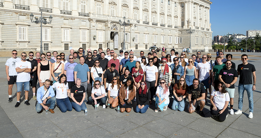 Comet team photo in front of a white building