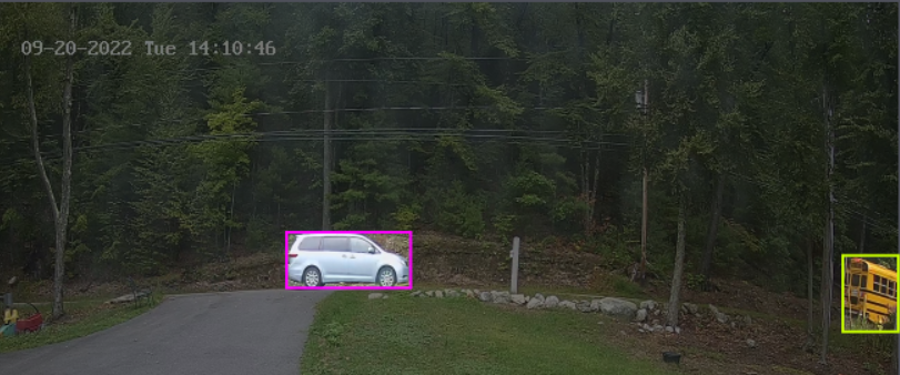 a car on a road with a pink box around it